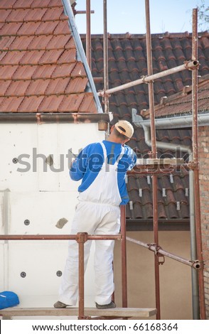 The worker placed the insulation on the building