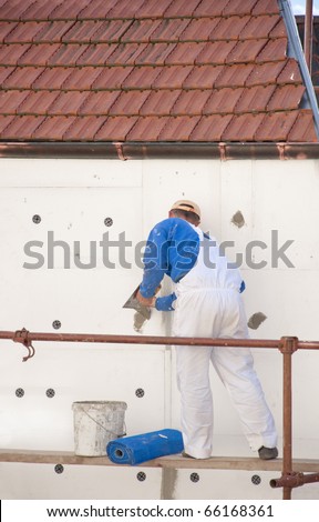 The worker placed the insulation on the building
