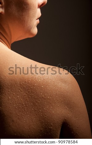 female shoulder with drops of water
