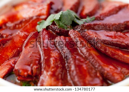 Chinese red-cooked pork belly on a white background