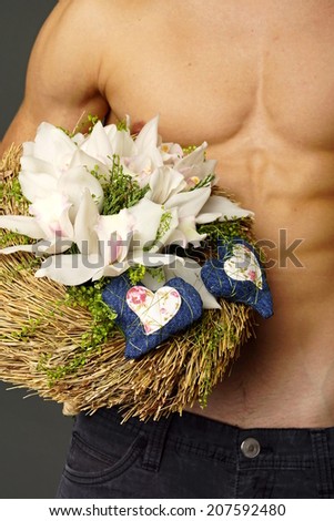 Athletic man with bouquet of orchids for Valentine