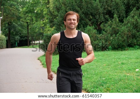 Portrait of a man running in park