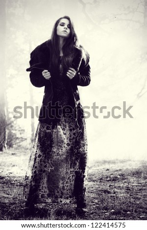 fine art photo. young beautiful woman in mysterious smoke forest