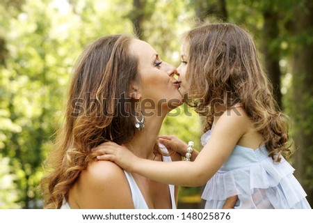 mother\'s love. mother and daughter kissing