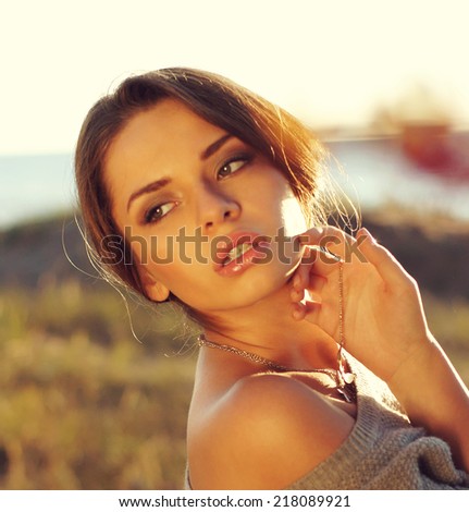 young beautiful sensual tender woman posing in autumn fields looking side way