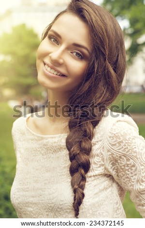 Young pretty woman summer outdoor portrait. Beautiful girl with stylish braid