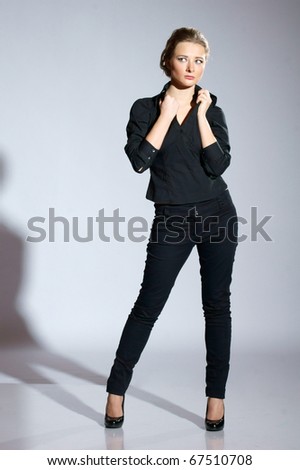 stock-photo-female-model-posing-in-black-clothes-in-studio-67510708 stock-photo-female-model-posing-in-black-clothes-in-studio-67510708