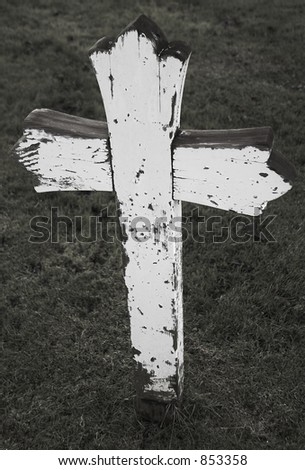 Old dilapidated wooden cross, wood rotten, paint peeling