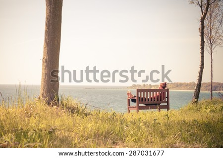 Woman relaxing by the sea
