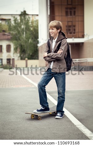 School teen with schoolbag and skateboard, day