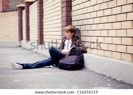 School teen with schoolbag and skateboard, day