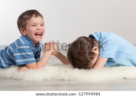 Arm wrestling and two brothers, indoor