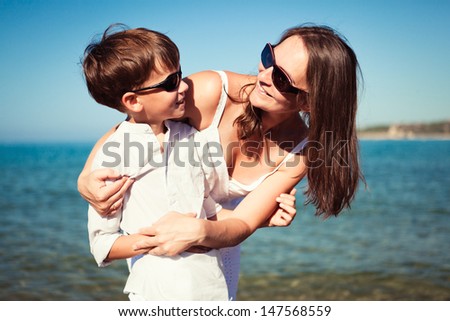 Portrait of happy mother and son at sea, outdoor