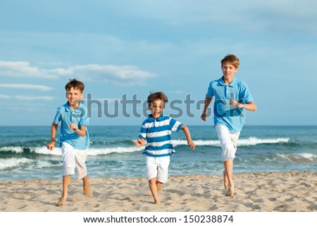 Three brothers are running on beach, outdoor