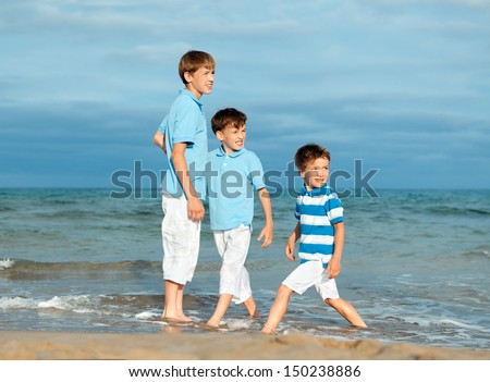 Three brothers are play on beach, outdoor