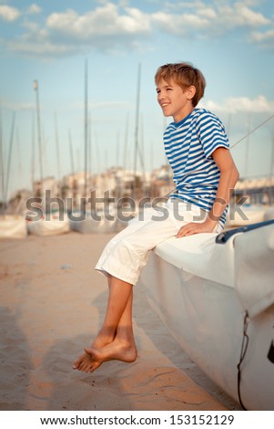 Portrait of young sailor near yacht, outdoor