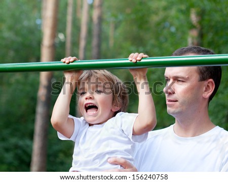 Father and son play sports, outdoor
