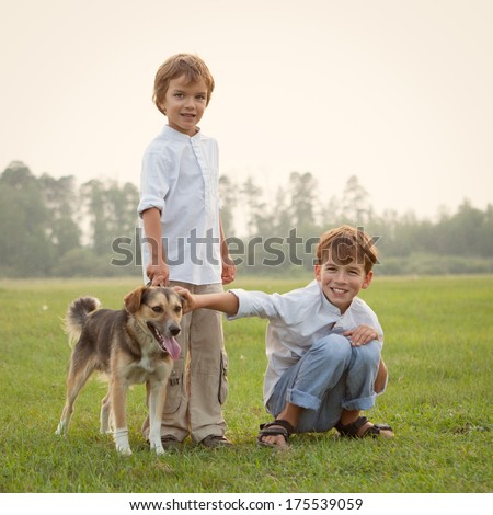 Happy children on walk with dog in park, smile, outdoor