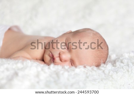 Portrait of cute sleeping newborn girl n white background, indoor