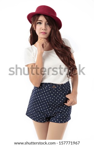 Beautiful young asian woman posing in dress with hat, white blouse and blue short isolated on white background.