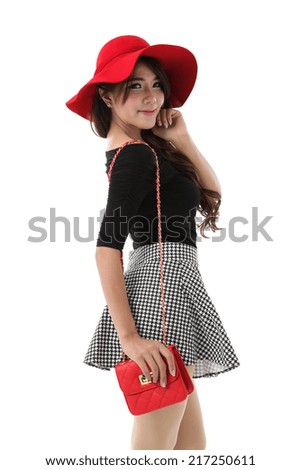 Asian woman full body posing in black cotton top dress and plaid skirt with red hat and shoulder red bag isolated on white background.