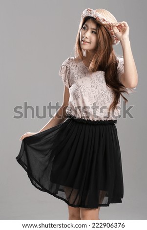 Asian girl posing in cream tone lace blouse and black chiffon skirt.
