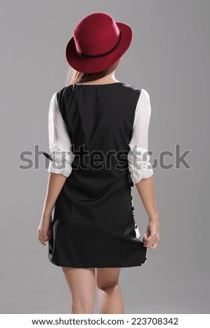 Asian girl posing in half sleeves black and white flower print front with black back short dress with hat.