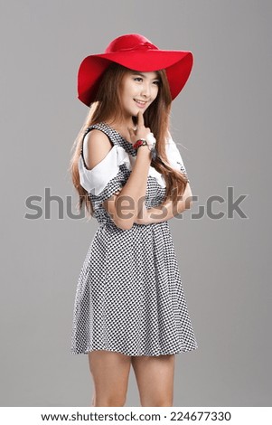 Asian Fashion Model in Cut Out Shoulder Waist Dress with red hat.