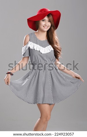 Asian Fashion Model in Cut Out Shoulder Waist Dress with red hat.