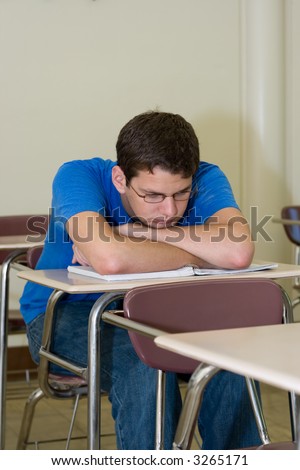 young male college student taking a break from studying for an exam
