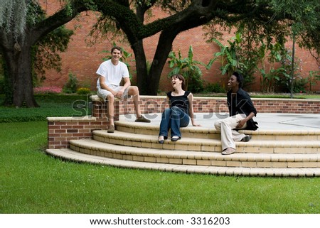 happy college students hanging out on campus