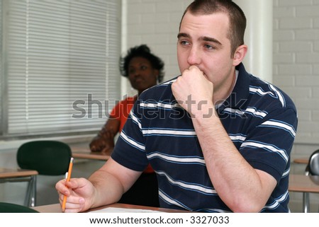 pensive male student paying attention in class