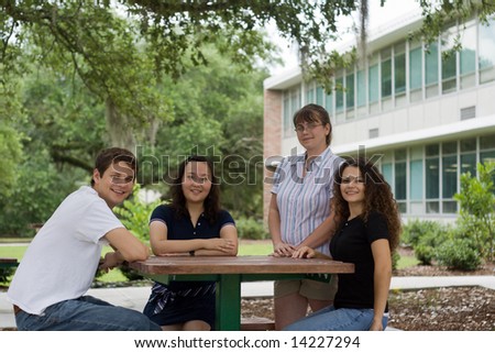a group of college students relax outside a classroom building