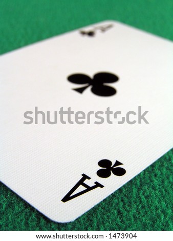 Ace of clubs on a green felt table top.