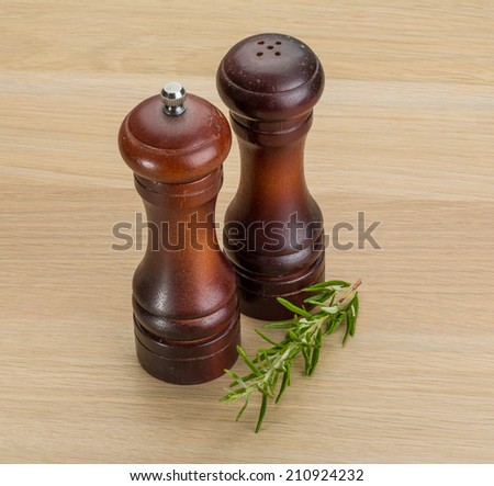 Pepper mill with rosemary on the desk