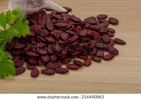 Red pumpkin seeds on the desk