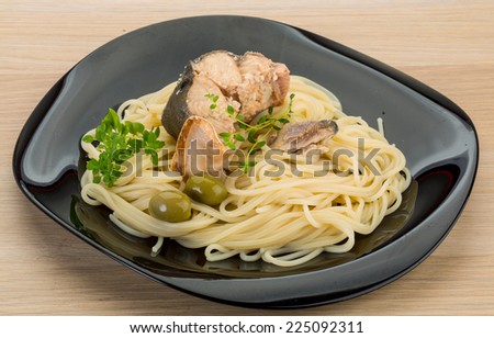 Pasta spaghetti with salmon and herbs on board
