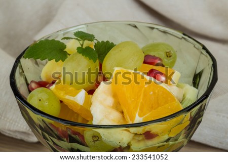 Fruit salad with banana, orange, kiwi and grape