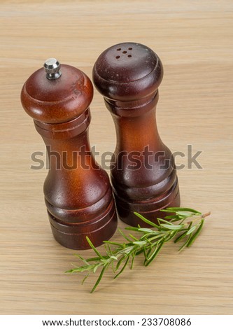 Pepper mill with rosemary on the desk
