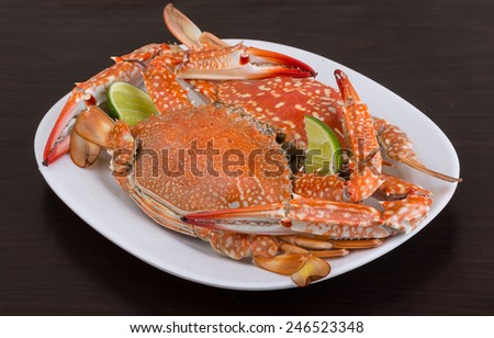 Boiled crabs with lime on the wood background