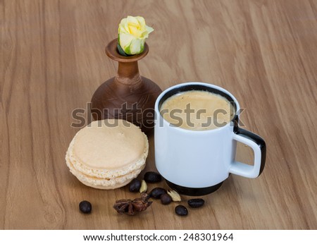Coffee with macaroons and yellow rose flower