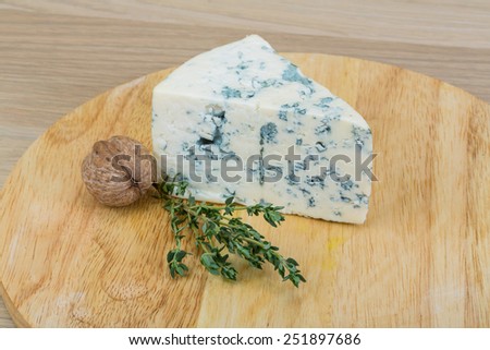 Blue cheese with mold on the wood background