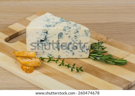 Blue cheese with mold on the wood background