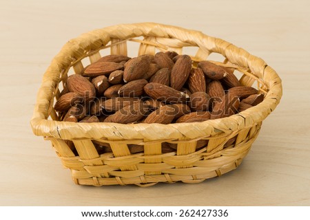 Roasted Almonds in the bowl on wood background