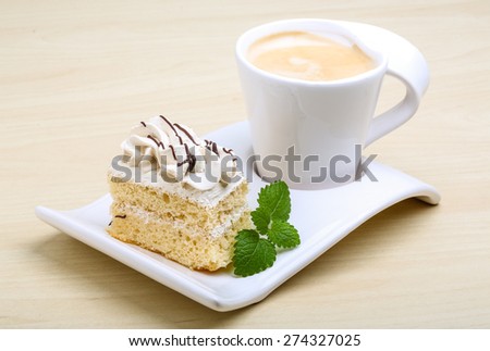 Coffee with cake and fresh green mint leaves