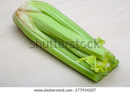 Green Celery sticks on the wood background