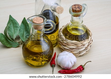 Olive oil in the bottles with laurel leaves