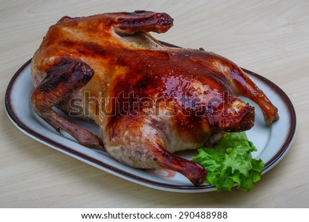 Roasted duck with salad leaves on the wood background
