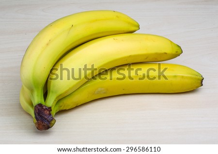 Bananas fruits heap - on the wood background