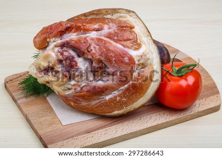 Smoked pork neck with dill on the wood background
